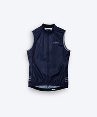 Female cyclist wearing Pedalare’s high-performance navy, blue cycling vest, layered over a navy long sleeve jersey and black bib shorts. Side profile studio shot showcasing the vest’s aerodynamic fit and premium detailing. Lightweight, windproof men’s cycling vest ideal for cool weather rides. Designed by Perth cycling brand Pedalare for performance, comfort, and style. Aero cycling gear for dedicated road cyclists.